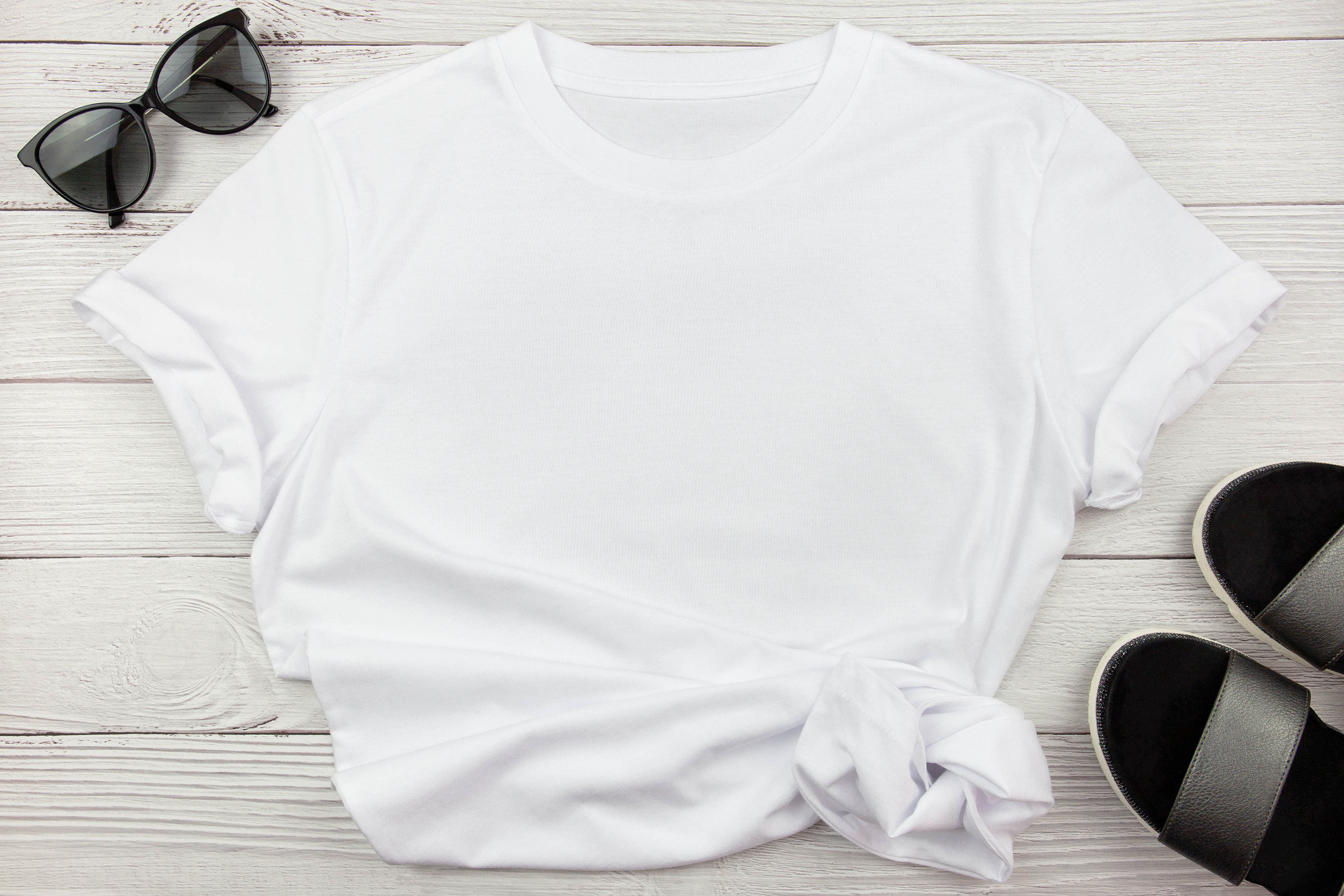 White Shirt with Accessories on Wooden Background